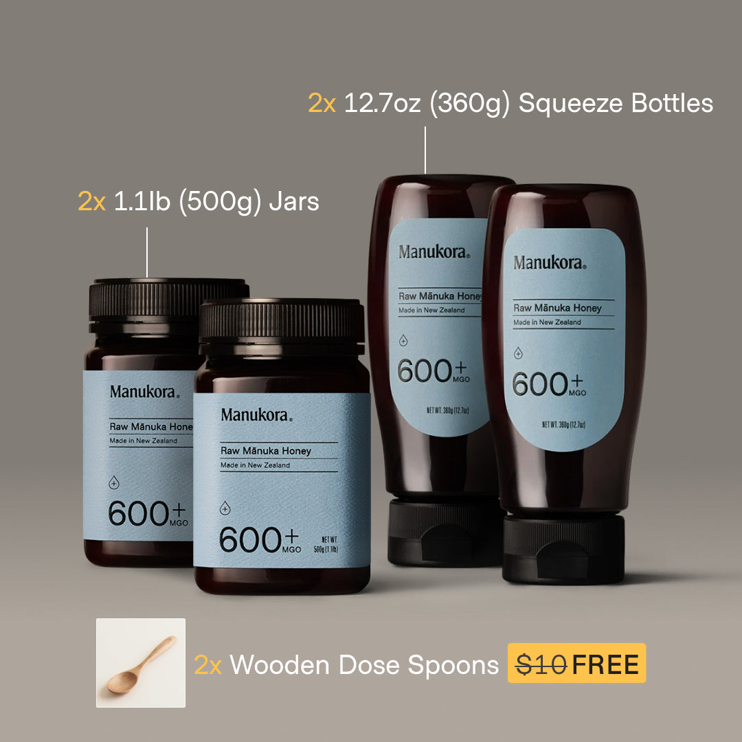 Two Manukora honey containers with free wooden spoon offer.